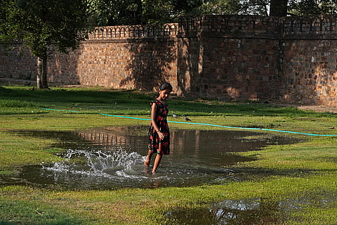 A girl plays in puddle
